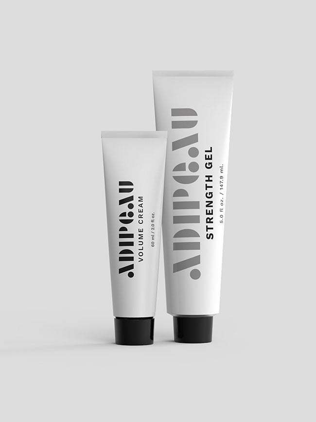 Adipeau Volume Cream and Strength Gel duo shot, both tubes standing upright