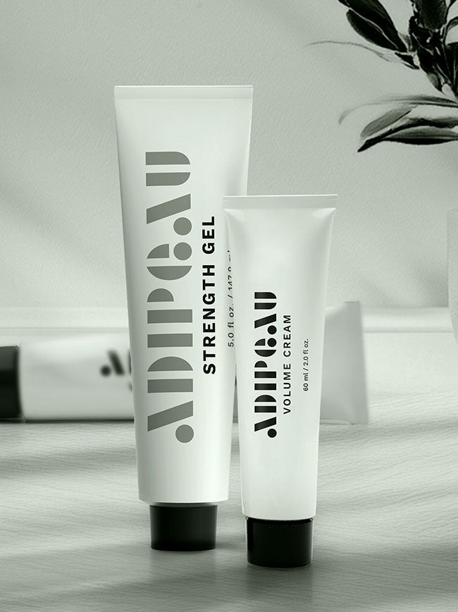 Two Adipau antiaging care products on a wooden surface with a blurred background