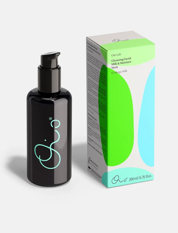 Oio Lab O Mega Milk Cleanser black pump bottle with a light blue abstract logo stands next to its product box, which features green and light blue abstract shapes on a white background. The box reads &