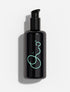 Oio Lab Omega Milk black pump bottle with a glowing mint green abstract logo, set against a clean white background with a soft shadow.