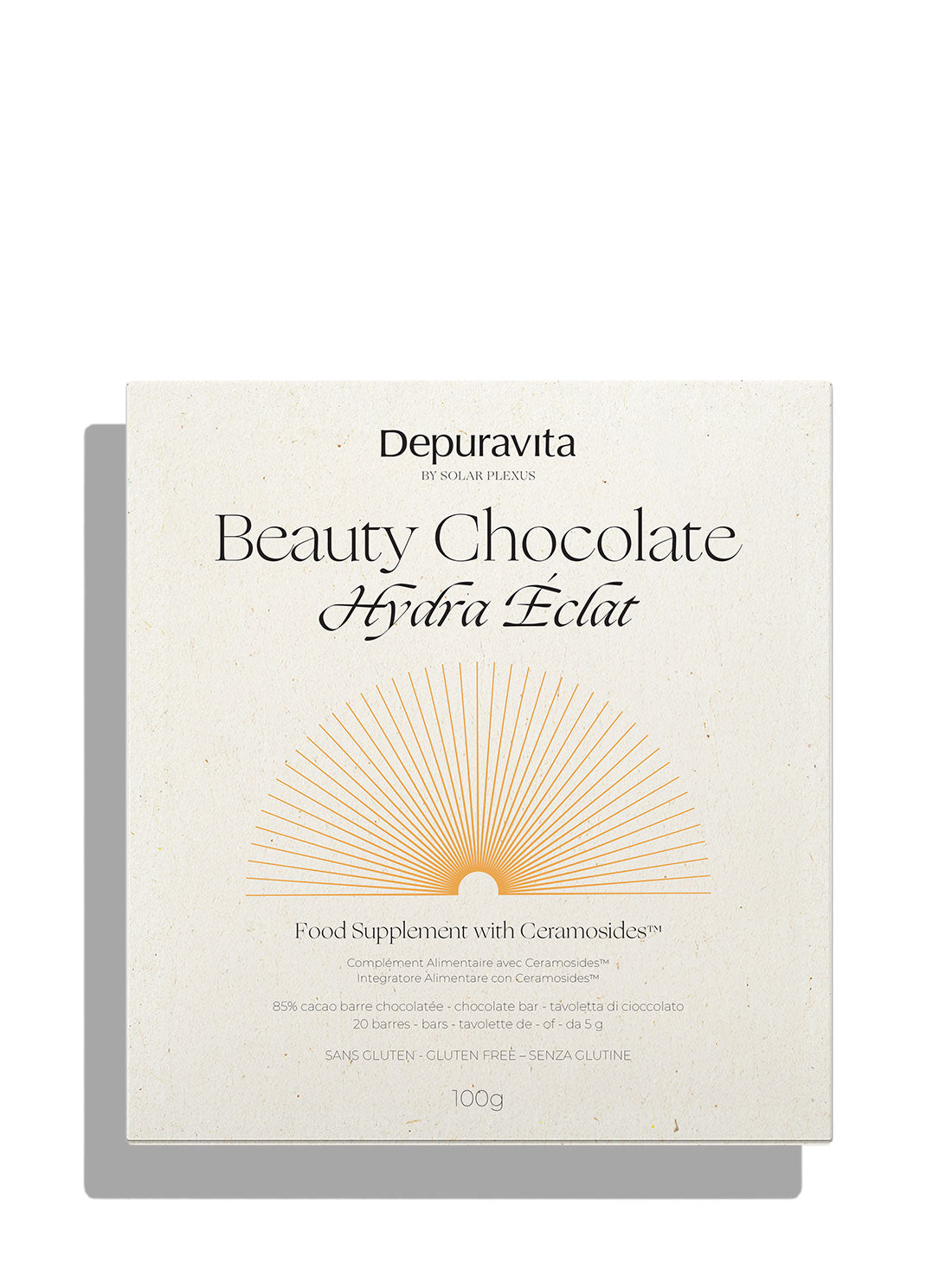 Depuravita Beauty Chocolate Hydra Éclat food supplement packaging, featuring a cream-colored box with elegant black typography and a gold sunburst graphic on a white background.