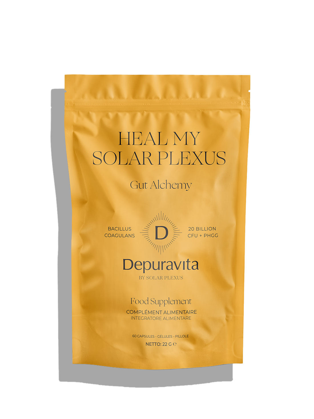 A stand-up pouch of Heal My solar Plexus Gut Alchemy Depuravita food supplement in a metallic gold color, featuring black text and a central &