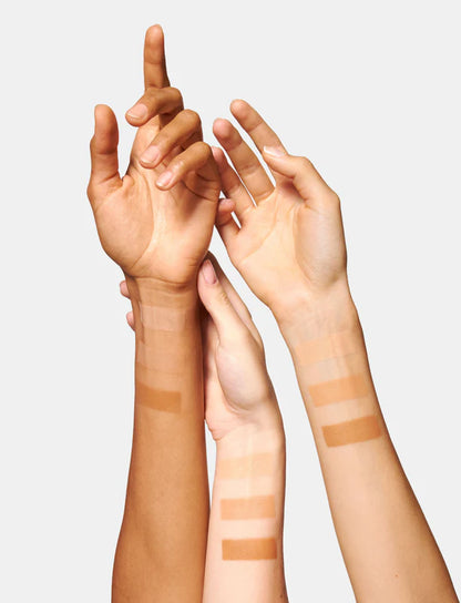 Model with radiant healthy looking skin wearing OIO Lab HOLITINT medium coverage tint