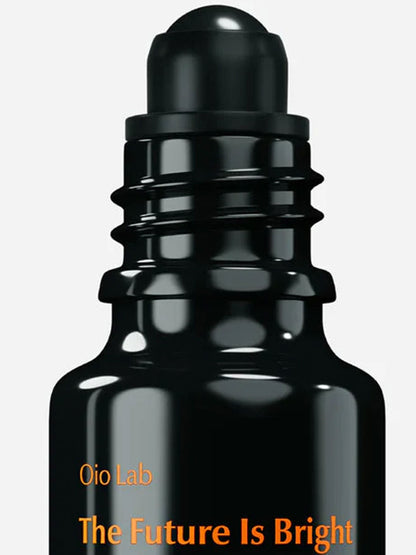 A close-up of a glossy black roll-on bottle with a ribbed cap, featuring orange text that reads &
